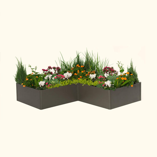 Urban Charcoal tall modern L-shaped raised garden bed with colorful flowers and plants on a white background.
