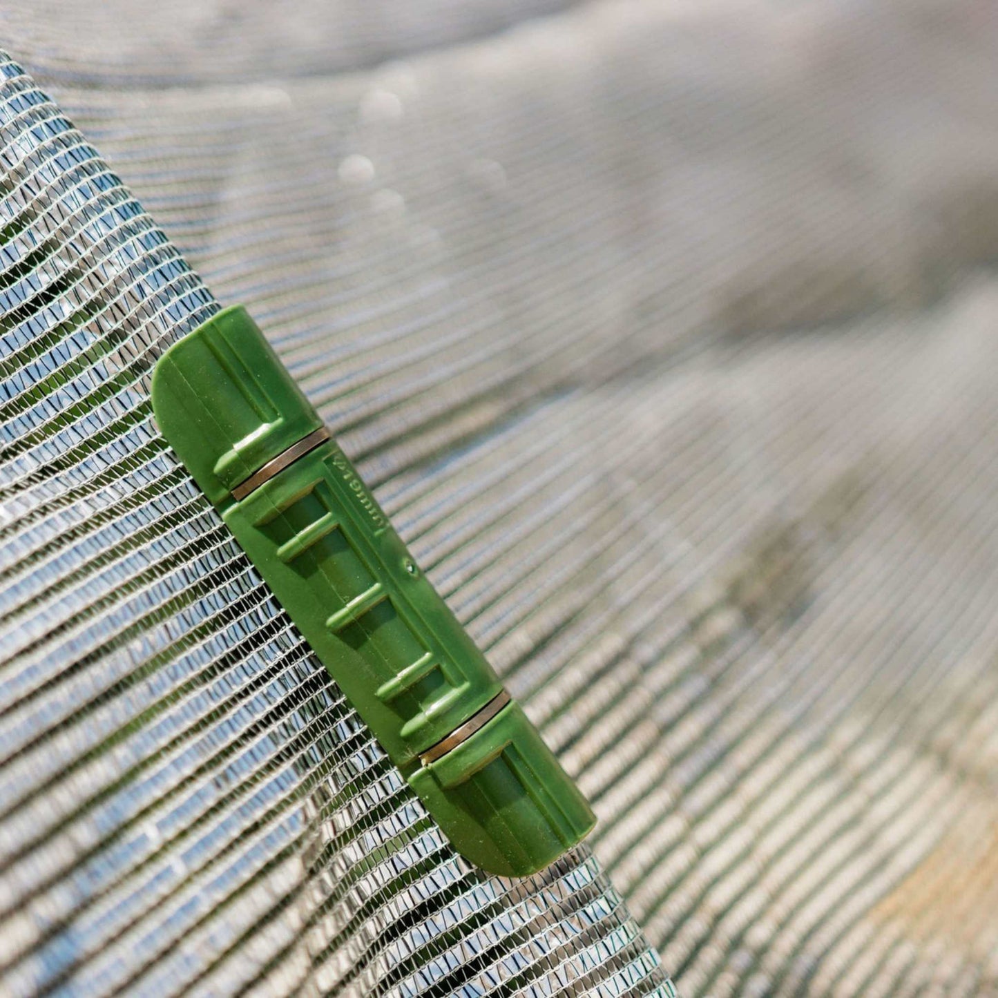 close up of white shade cloth with shade cloth clip in use