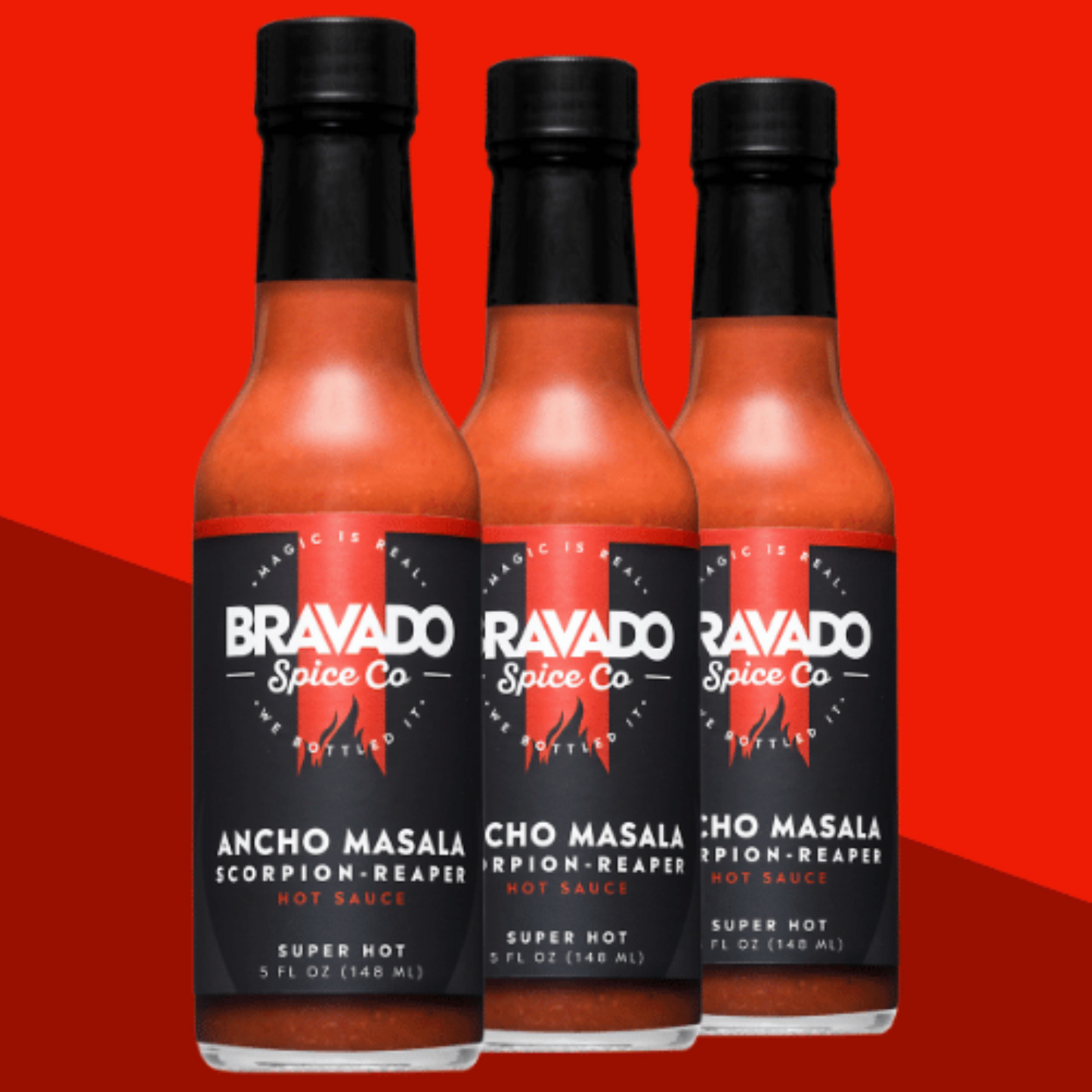 Three bottles of Ancho Masala Scorpion Reaper hot sauce on a red background