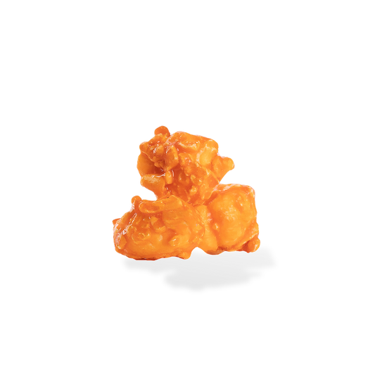 Three pieces of Orange popcorn on a white background