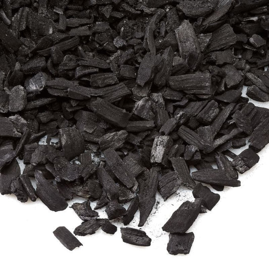 Close-up of biochar pieces on a white background