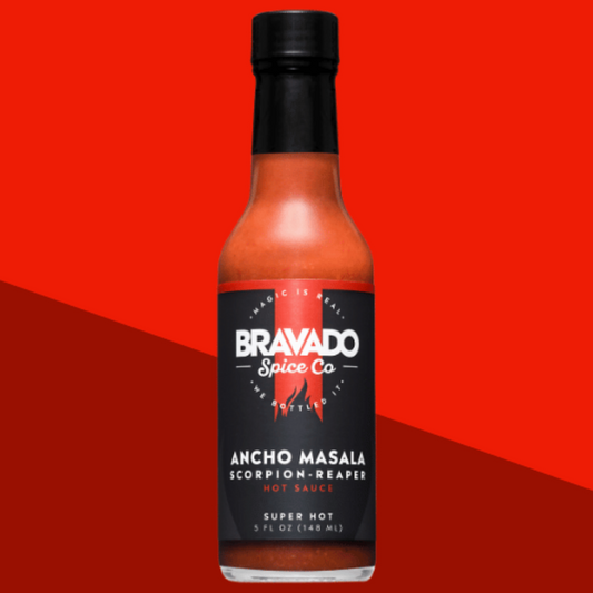 Ancho Masala Scorpion Reaper hot sauce bottle on a red background