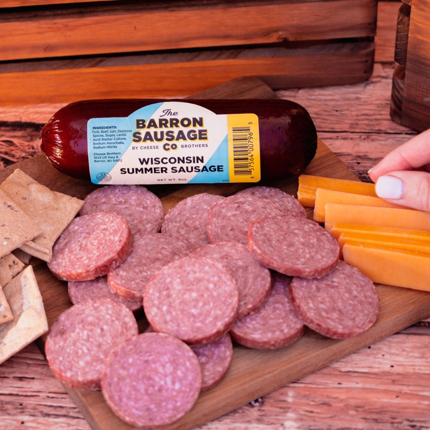 Barron Sausage Wisconsin Summer Sausage on a wooden board with crackers, cheese, and sausage slices.