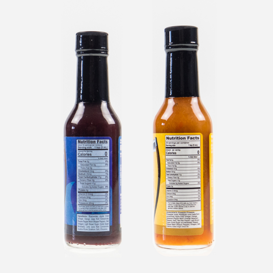 Back label of Blueberry Carolina Reaper Hot Sauce bottle and Pineapple Reaper Hot Sauce showing ingredients and nutrition facts on a white background