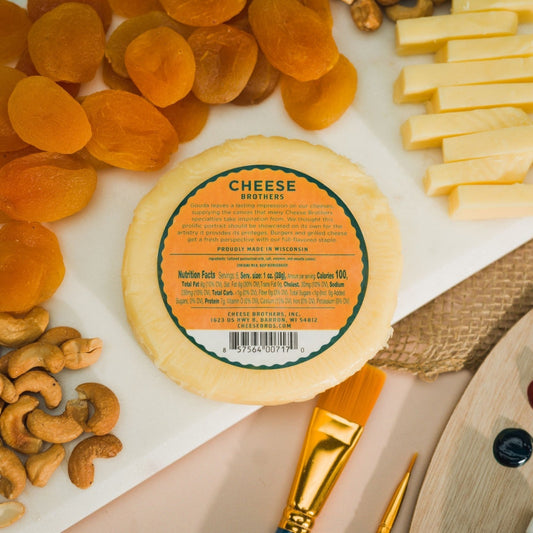 classic gouda cheese label on board with apricots and cashews