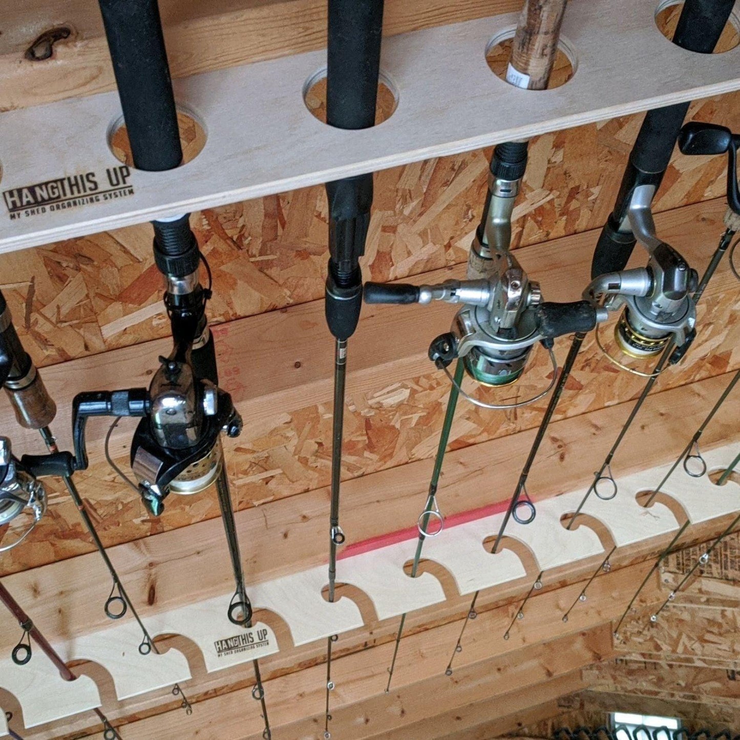 Close-up of both racks with the fishing rod rack stud mount organizer installed on ceiling studs and fishing rods in the rack.