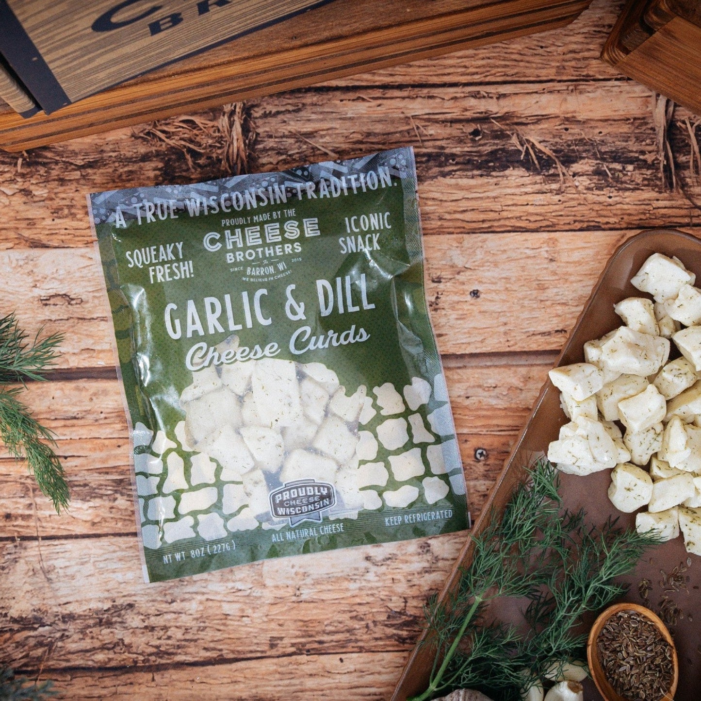 garlic and dill cheese curds displayed on wooden board