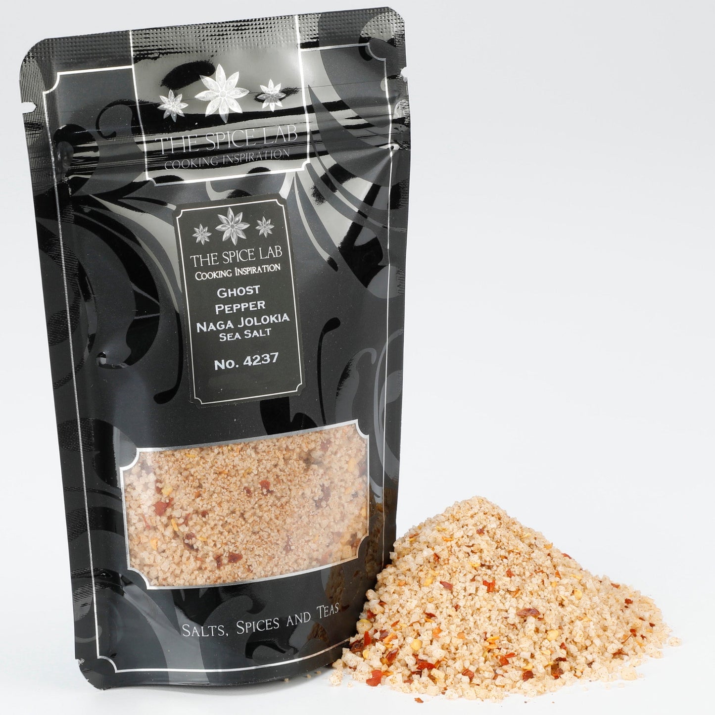 Black packaging with visible spices for the ghost pepper naga jolokia salt on a white background