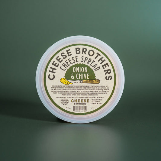 Onion and Chive Cheese Spread container presented in front of a plain green background