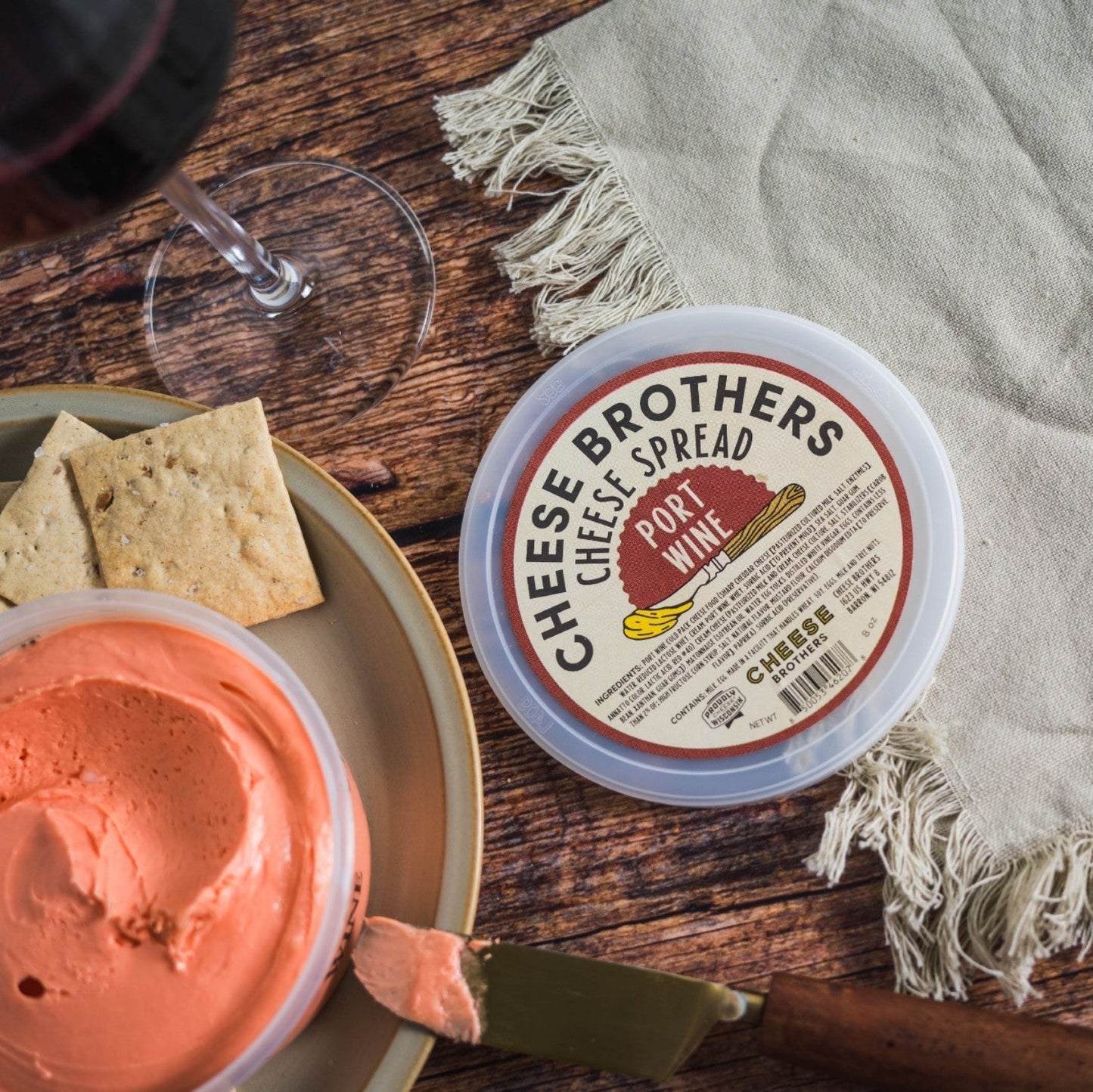 cheese brothers port wine cheese spread on wooden table with crackers