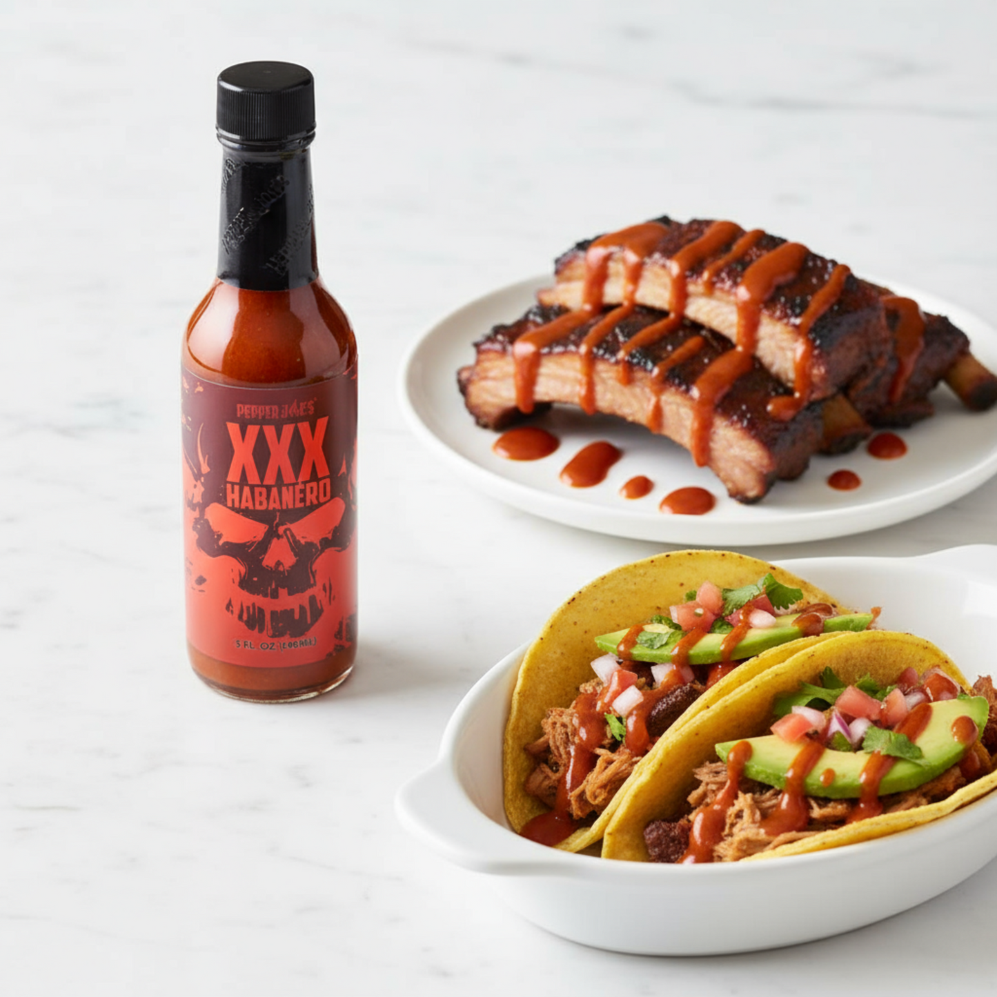 XXX Habanero Hot Sauce bottle on a white kitchen counter beside a plate of tacos and a plate of grilled pork drizzled with spicy hot sauce.