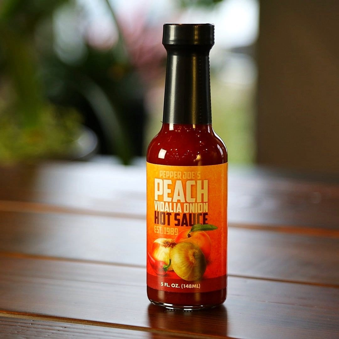 Pepper Joe's Gourmet Peach Vidalia Onion Hot Sauce - Georgia Peach Hot Sauce on wooden table