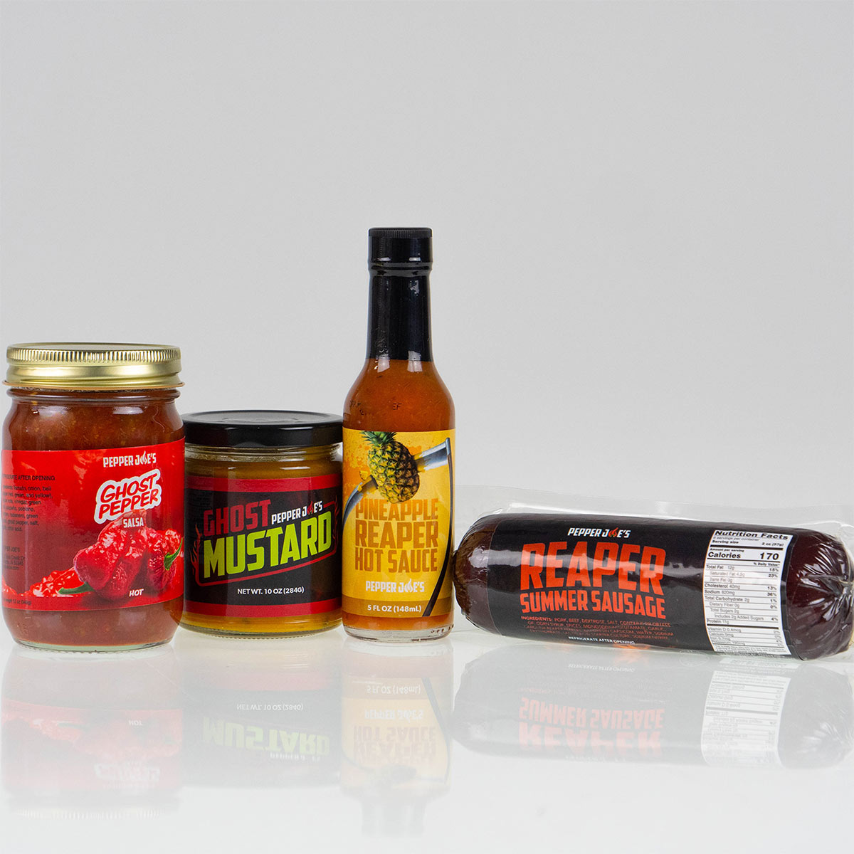 Pepper Joe's Reaper Vs. Ghost Pepper Extra Spicy Gift Bundle - spicy snacks and sauce on white background