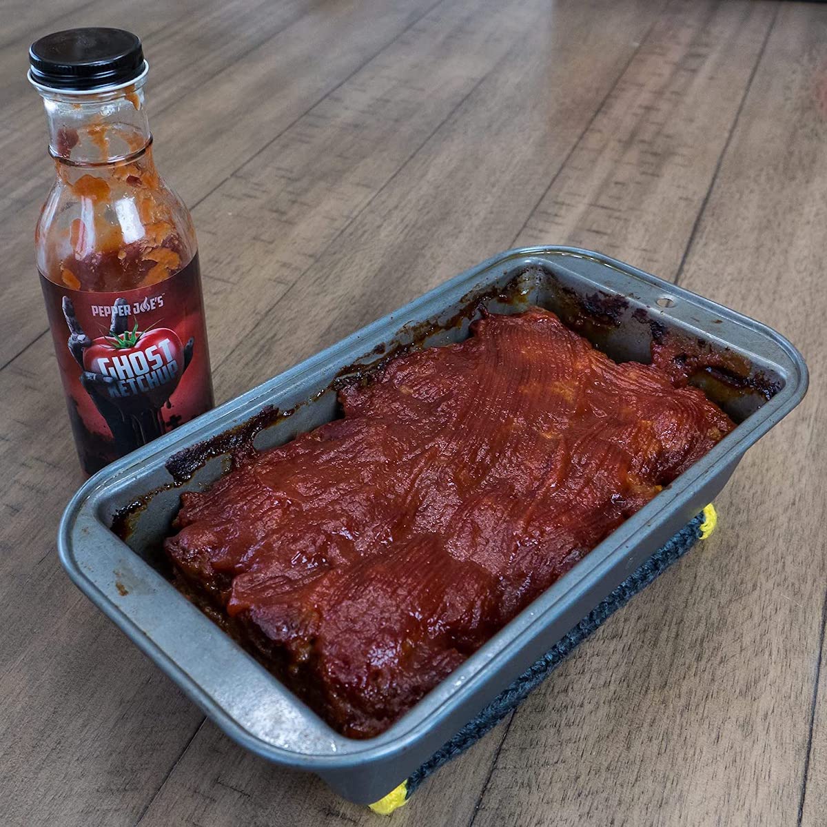 Pepper Joe's ghost pepper ketchup - hot and spicy ketchup spread on meatloaf in baking pan