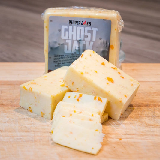 Pepper Joe's spicy Ghost Pepper Monterey Jack Cheese block on wood cutting board