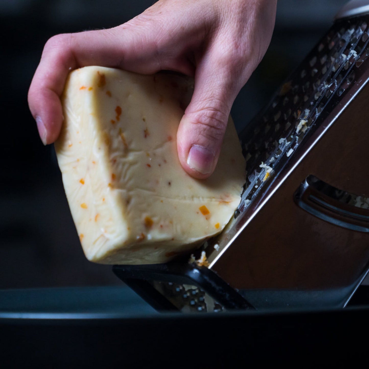 Pepper Joes spicy Ghost Pepper Monterey Jack Cheese being grated