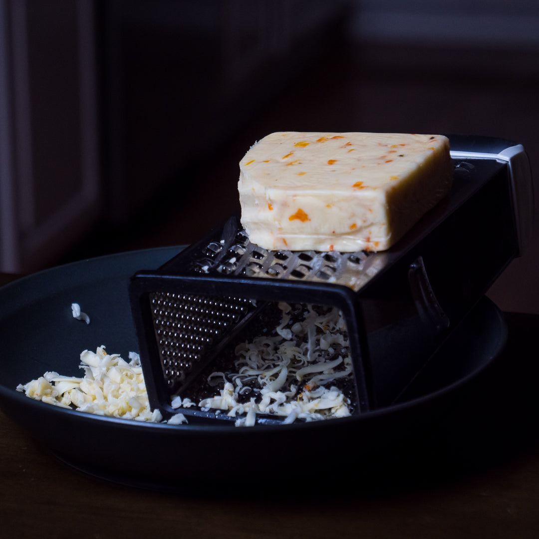 pepper joes spicy Ghost Pepper Monterey Jack Cheese being grated in black bowl