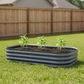 11 inch tall 6-1 modern Gray metal raised garden bed with three young pepper plants in backyard. 
