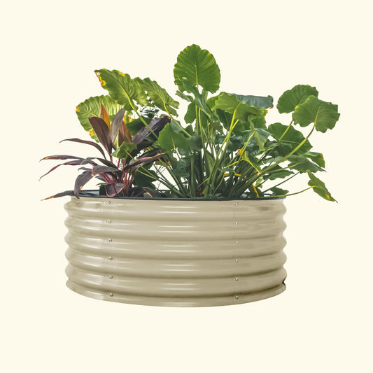 A pearl white 42 inch round metal raised garden bed with colorful flowers and plants on a white background