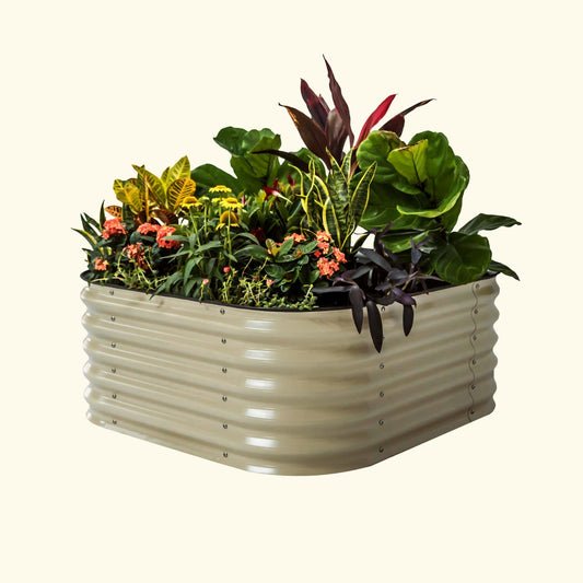 A pearl white 4 in 1 small modular metal raised garden bed with colorful flowers and plants on a white background.