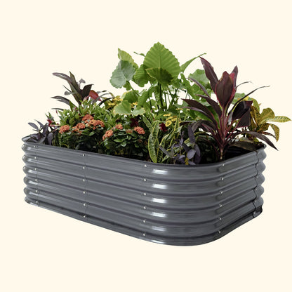 A modern gray 6 in 1 small modular metal raised garden bed with colorful flowers and plants on a white background.