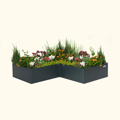 Midnight Blue tall modern L-shaped raised garden bed with colorful flowers and plants on a white background.