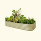 A pearl white modular metal raised garden bed kit filled with various plants and vegetables.