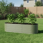 Olive green modular raised bed with three pepper plants in backyard