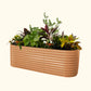 A terra cotta extra tall 10 in one Jumbo Modular Metal Raised Garden Bed metal raised garden bed with colorful flowers and plants on a white background.