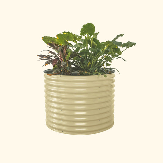 A pearl white 32 inch extra tall  42 inch wide round modern metal Garden Bed with colorful flowers and plants on a white background.