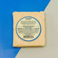 8 year aged cheddar block of cheese with nutrition and ingredients label presented on plain blue and white background