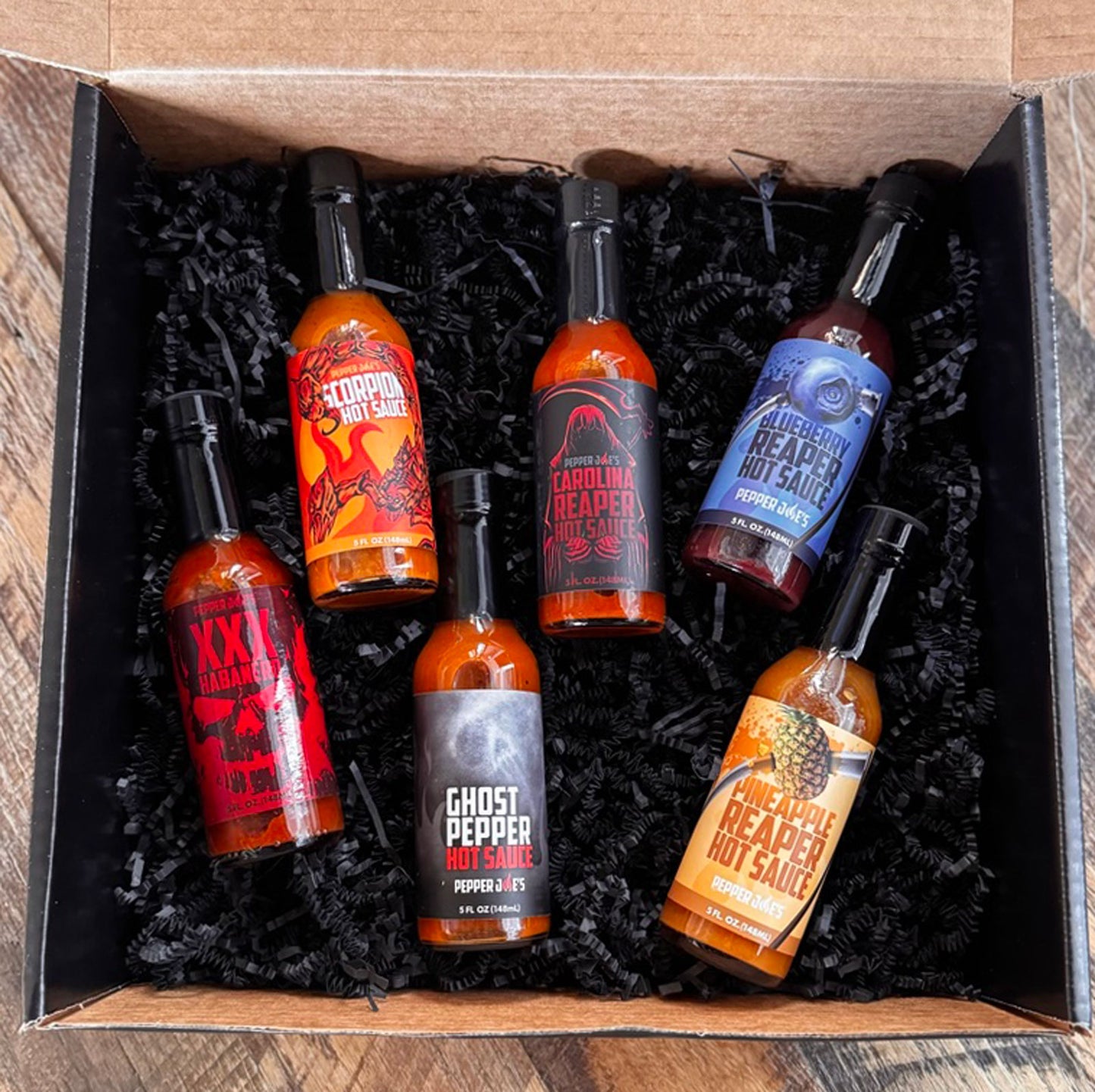 Six assorted Pepper Joe's hot sauces displayed for Build Your Own 6-Pack bundle