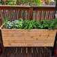 Cedar Planters 18x48 inch raised garden bed with plants in a backyard setting.