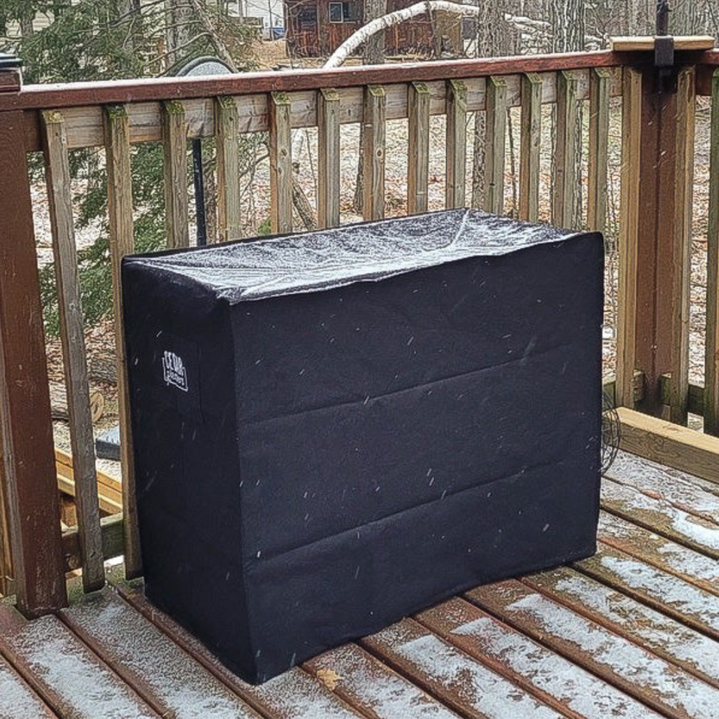Cedar Planters winter cover with snow cover on a wooden deck during a snowfall.