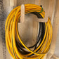 One pair of Hose/Extension Cord Organizer racks installed on an unfinished shed wall with hoses neatly hanging. 