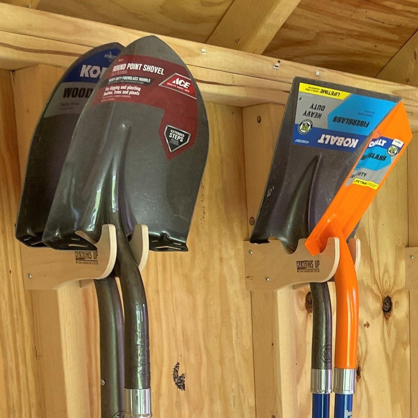Two pairs of the Garden Yard Tool Organizers installed inside an unfinished shed with shovels hanging  neatly. 