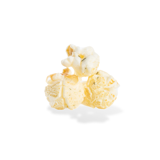 Three pieces of Dill Pickle popcorn on a white background