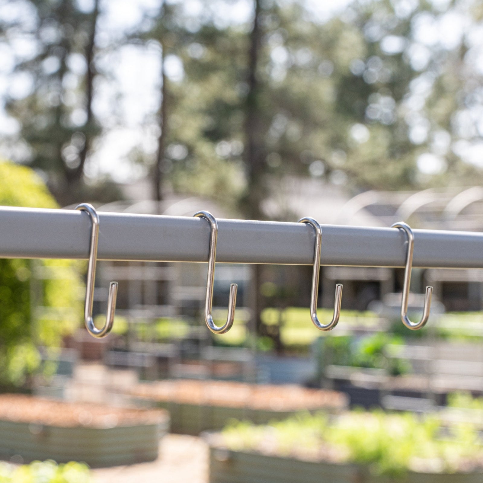 Accessory rack with hooks on a blurred outdoor background. 