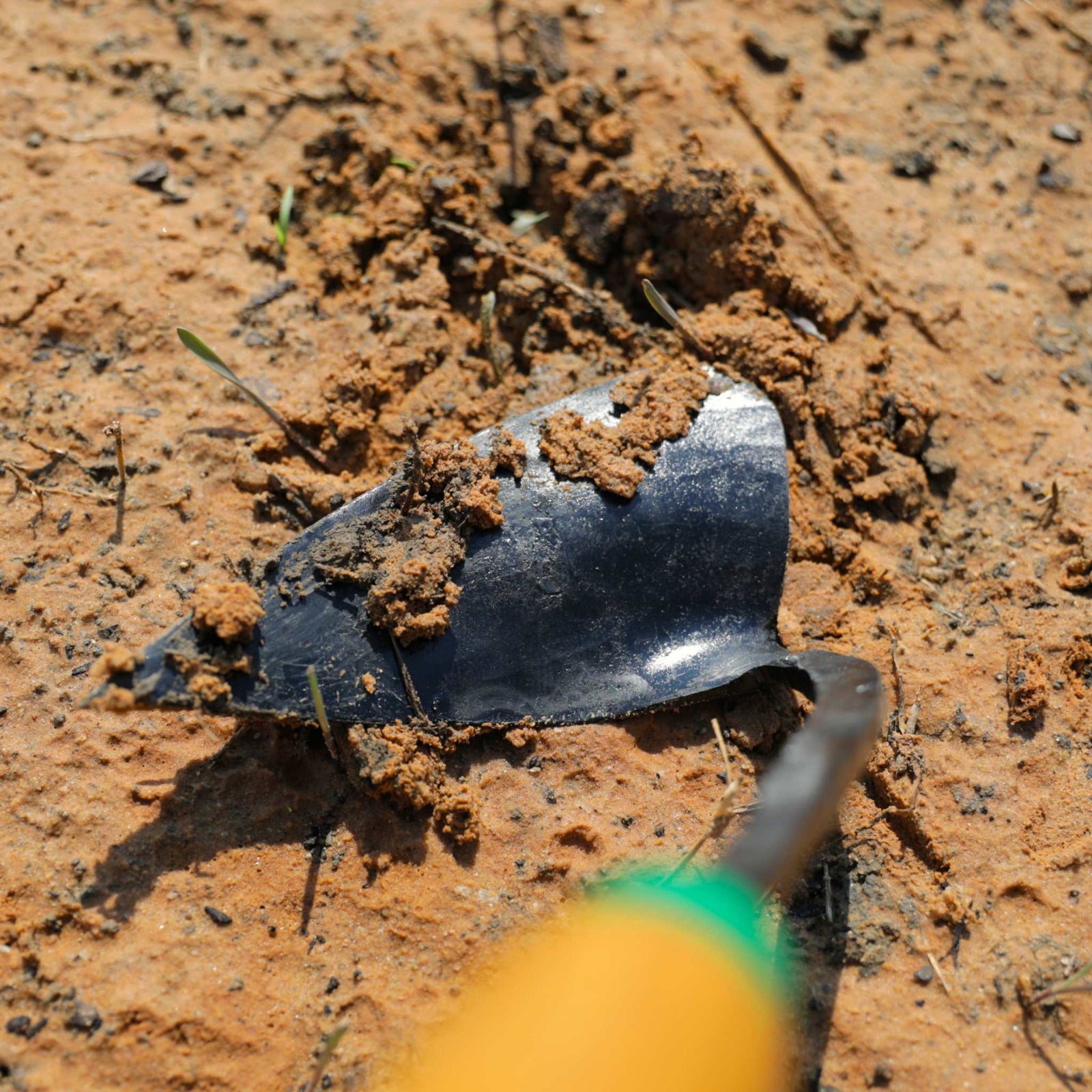 EZ-Digger Korean triangle blade tool in use in red clay soil