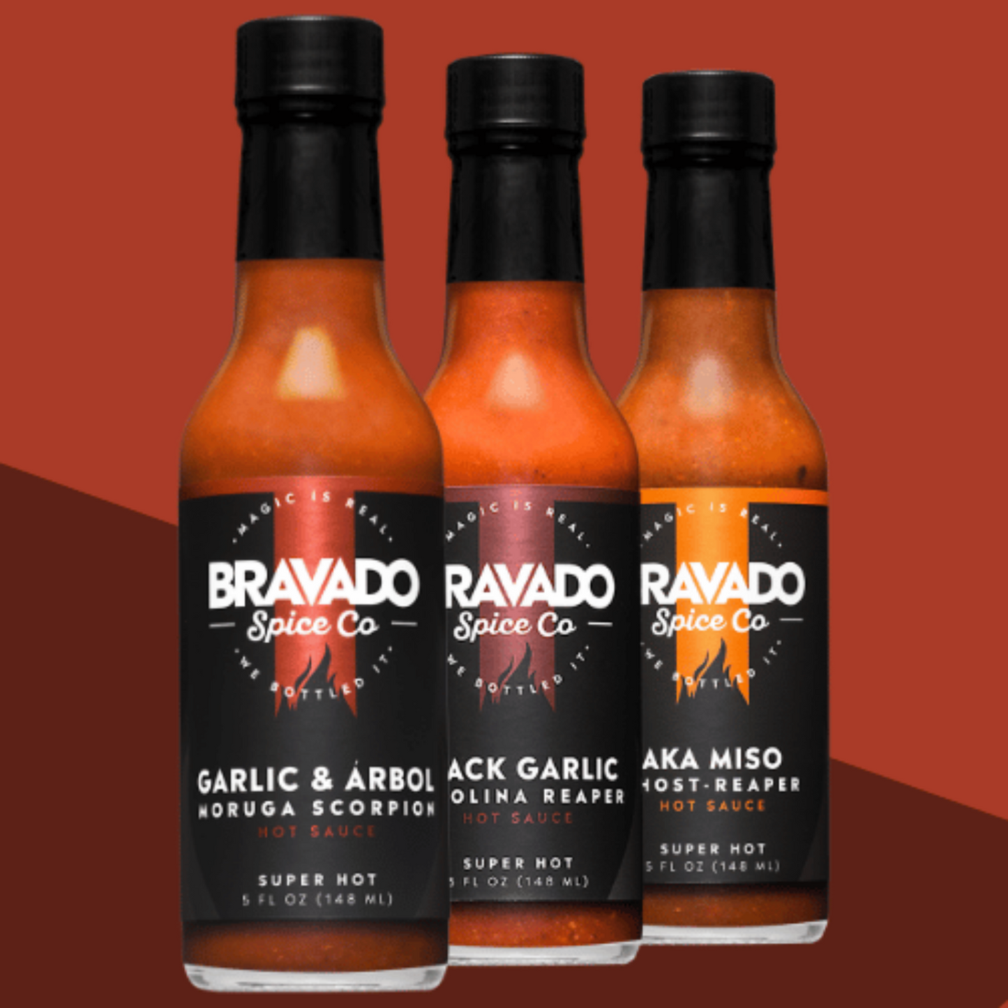 Three bottles of hot sauce on a brown gradient background with Garlic & Arbol Moruga Scorpion, Black Garlic Carolina Reaper, and AKA Miso Ghost Reaper flavors.