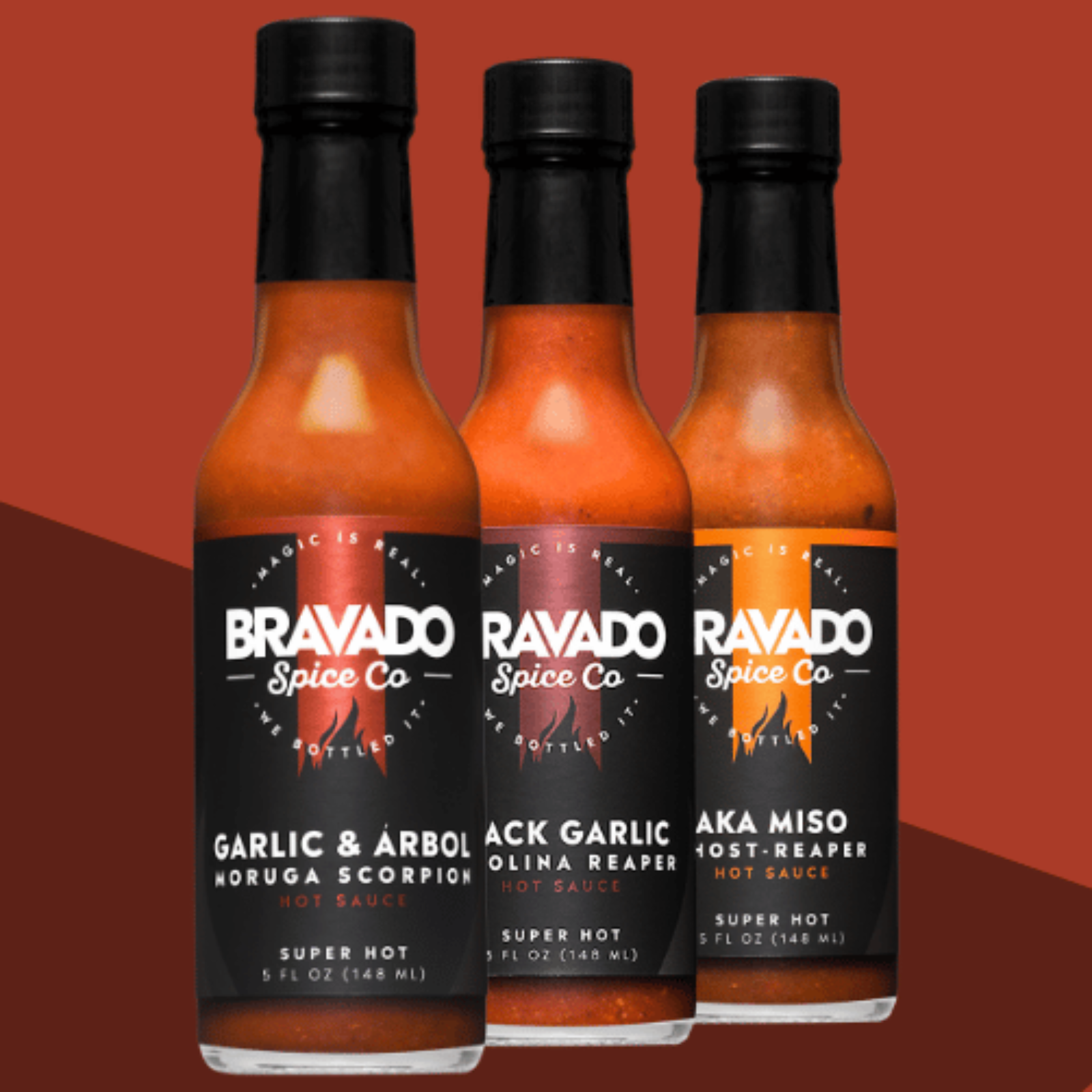 Three bottles of hot sauce on a brown gradient background with Garlic & Arbol Moruga Scorpion, Black Garlic Carolina Reaper, and AKA Miso Ghost Reaper flavors.