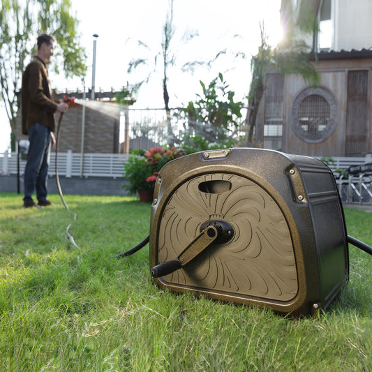 Heavy-Duty Garden hose reel on grass with a person using a hose in the background