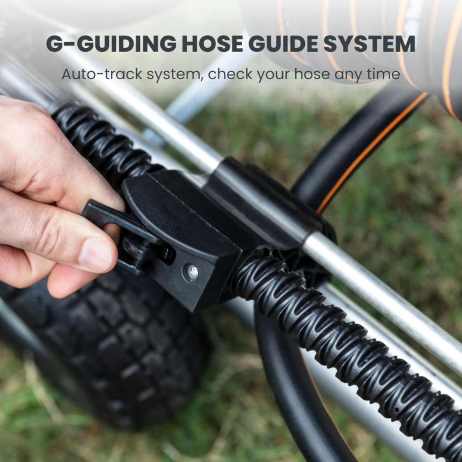 G-guiding hose guide system with a hand holding it on the Heavy Duty Garden Hose Reel cart sitting on a grassy background.
