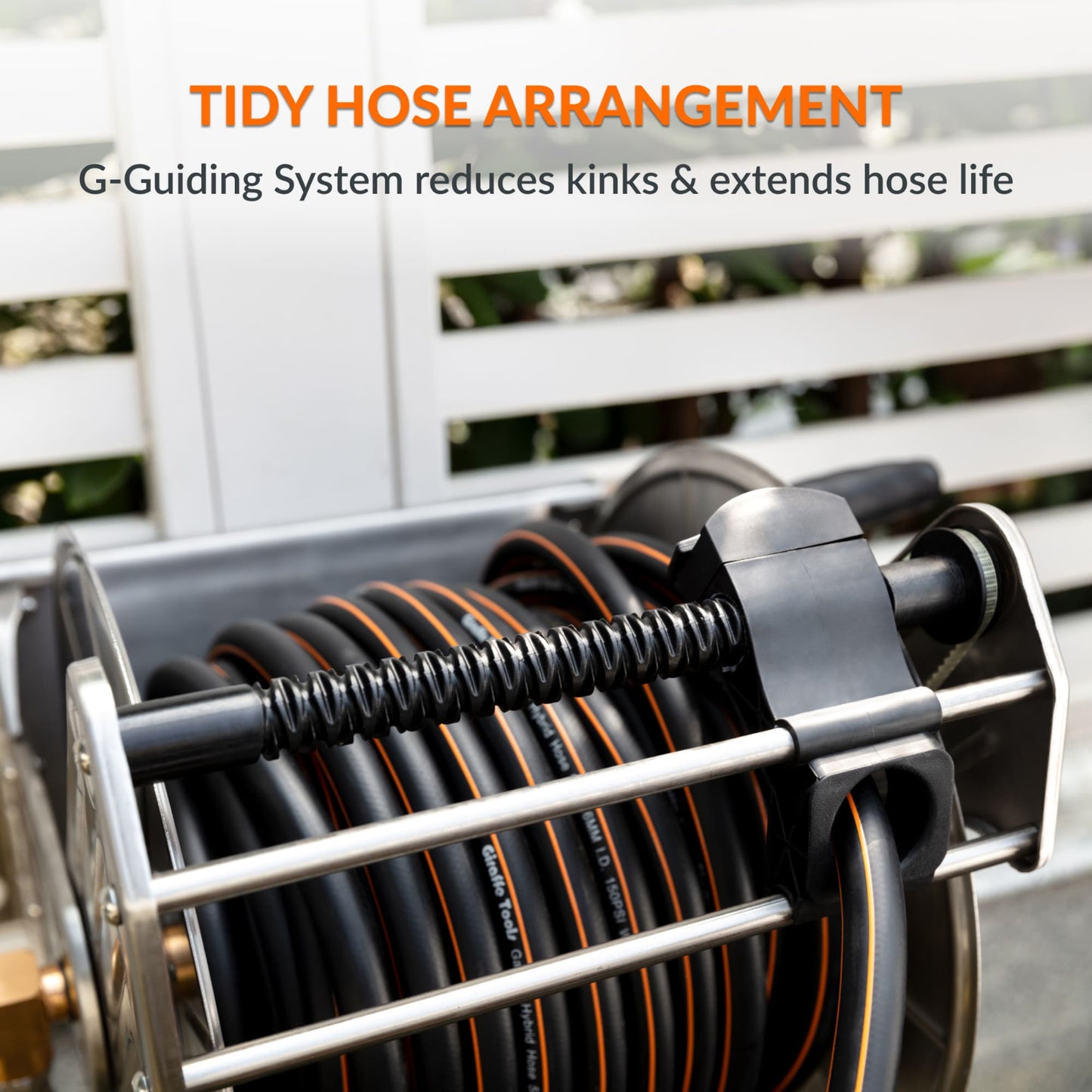 Heavy-duty wall-mounted stainless steel garden hose reel with tidy hose arrangement and text about G-Guiding System to reduce kinks and extend hose life.