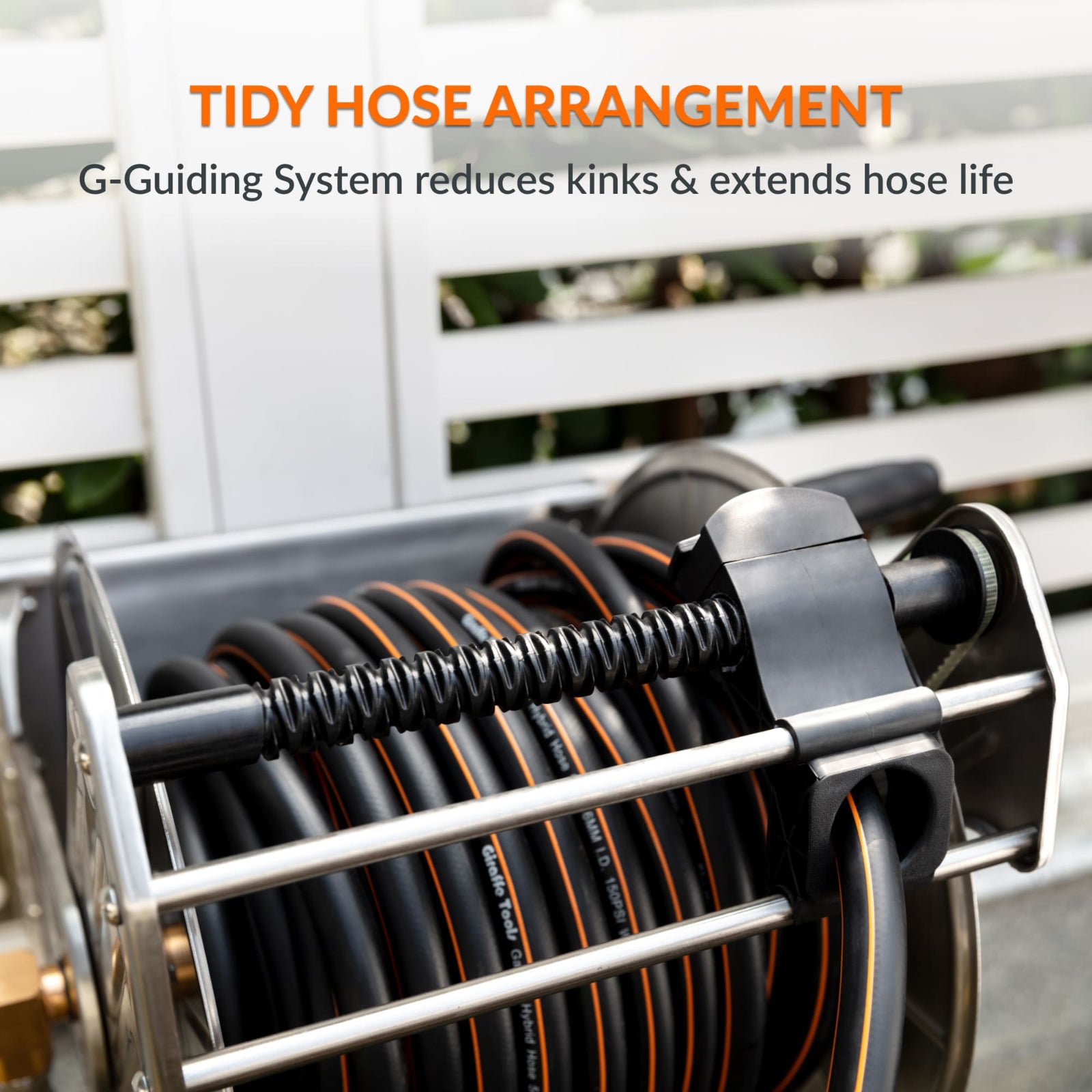 Heavy-duty wall-mounted stainless steel garden hose reel with tidy hose arrangement and text about G-Guiding System to reduce kinks and extend hose life.