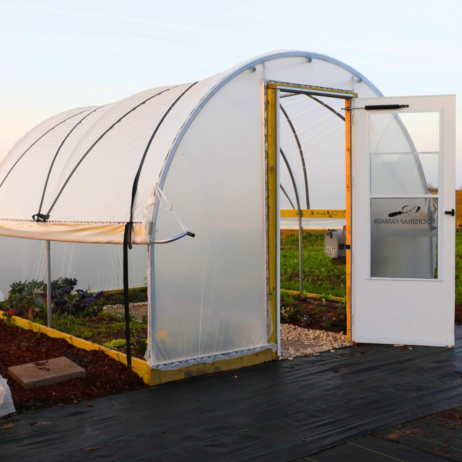 Hobby Greenhouse Kit with Batton Strapping installed in a backdoor setting.
