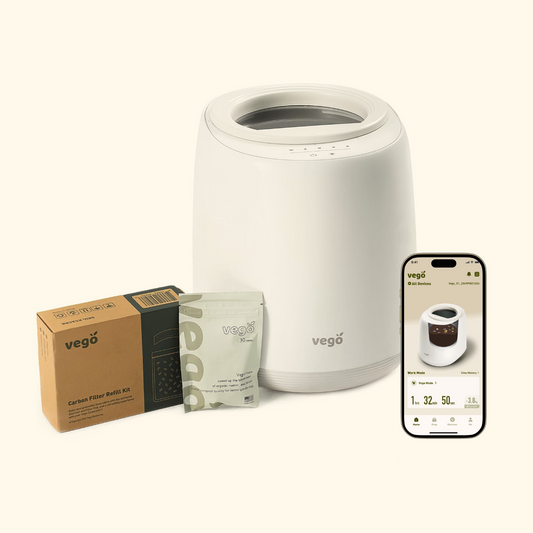 Kitchen Composter in white with a filter refill kit, Vego tabs, and a phone with the included app visible.