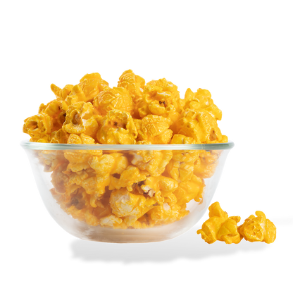 Mac and Cheese Popcorn popped in a bowl on a white background
