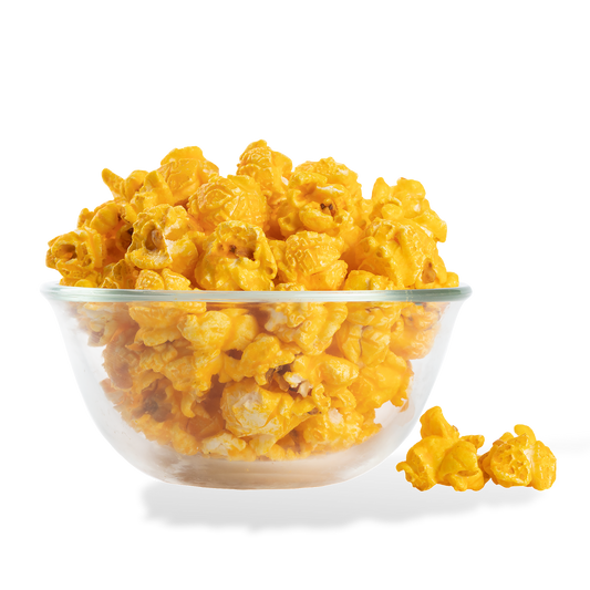 Mac and Cheese Popcorn popped in a bowl on a white background