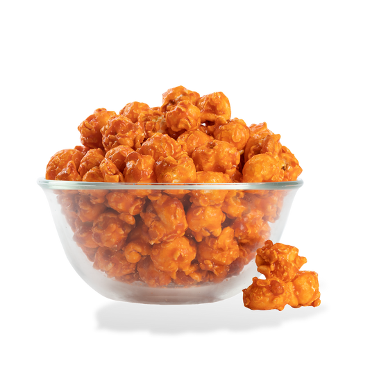 Orange Popcorn popped in a bowl on a white background